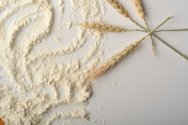 Flour, wheat, rice, raisins and coins on a white background