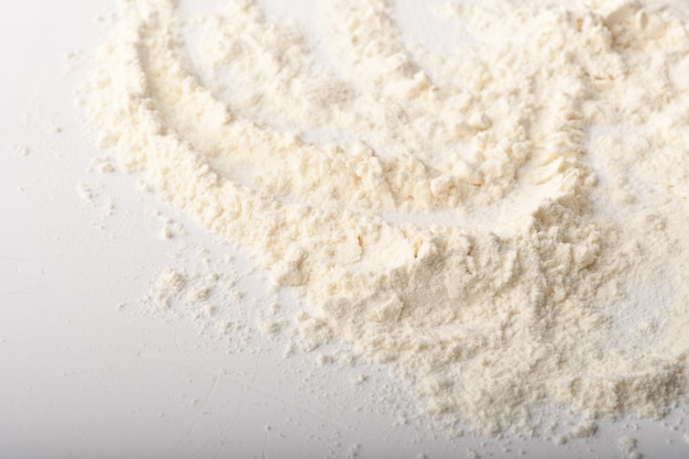 Flour, wheat, rice, raisins and coins on a white background