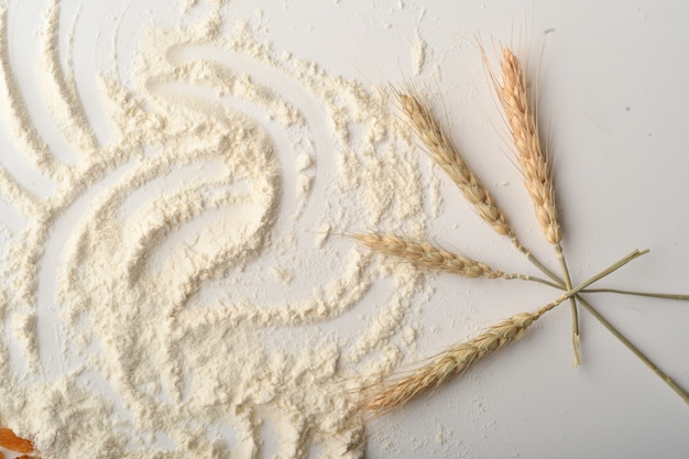 Flour, wheat, rice, raisins and coins on a white background