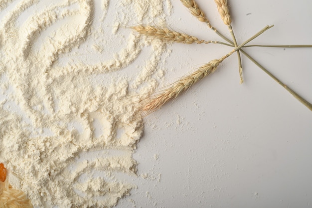 Flour, wheat, rice, raisins and coins on a white background