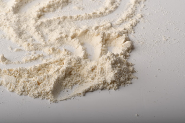 Flour, wheat, rice, raisins and coins on a white background