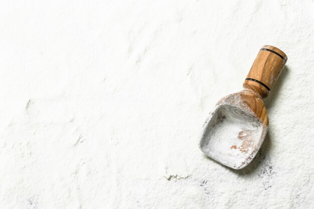 Flour with a wooden scoop.