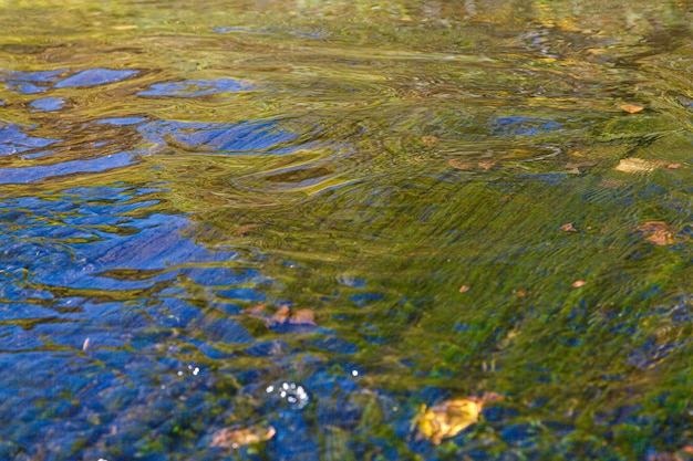 Photo flow of water and spray from a stone close up