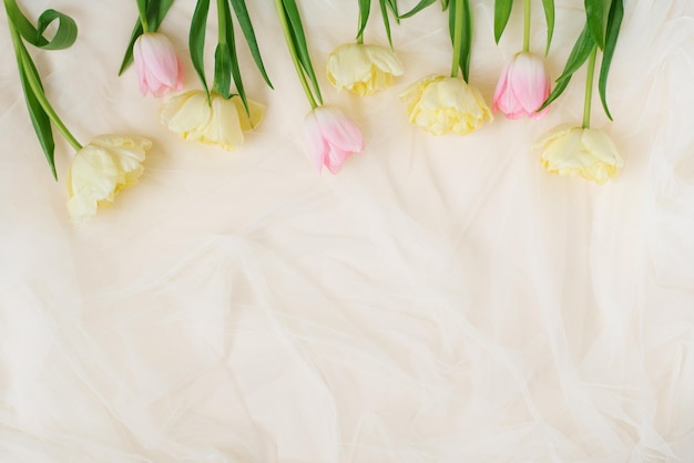 Flower arrangement for a birthday or mother's day Pink and yellow flowers on a beige background