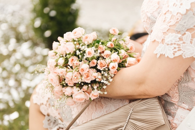 Flower arrangement for a gift in the hands of a woman