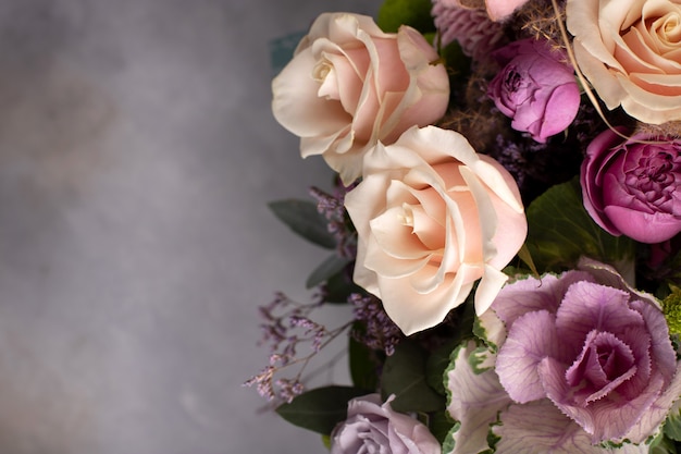 Flower border of assorted fresh flowers on a gray background. horizontal image, copy space, top view