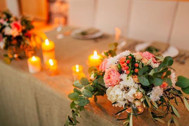 Flower compositions on the wedding table in rustic style wedding decorations with their own hands