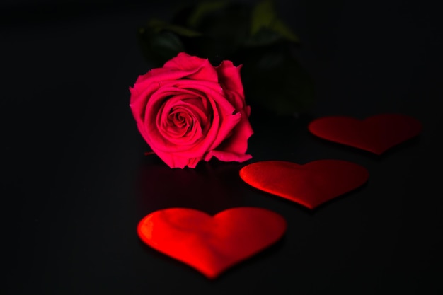 Flower and hearts on a black background