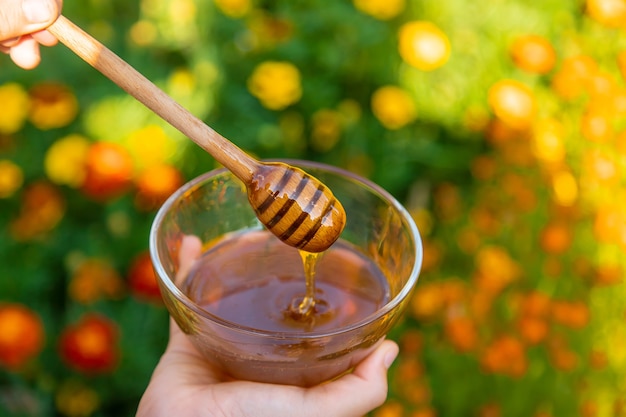 Flower honey in the hands of a child. Selective focus.