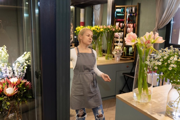 Flower shop worker chooses flowers for a bouquet