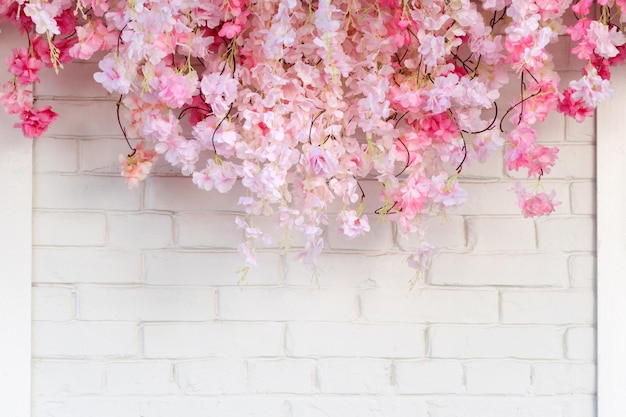 Flower texture background for wedding scene flowers on white brick wall with free space for text wed...