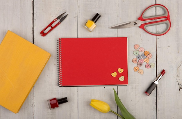 Flower tulip blank red note pad yellow book scissors nail polish lipstick and buttons