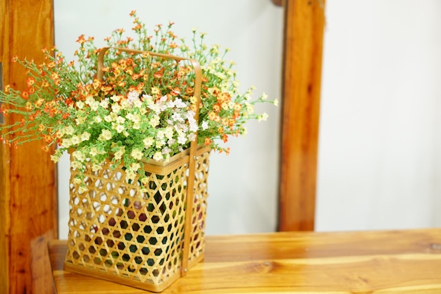 Flowers in the basket are placed on the table in the coffee shop