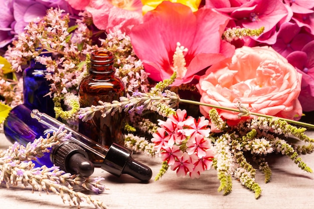 Flowers and bottles of essential oils for aromatherapy