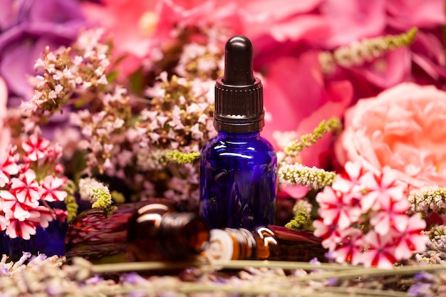 Flowers and bottles of essential oils for aromatherapy