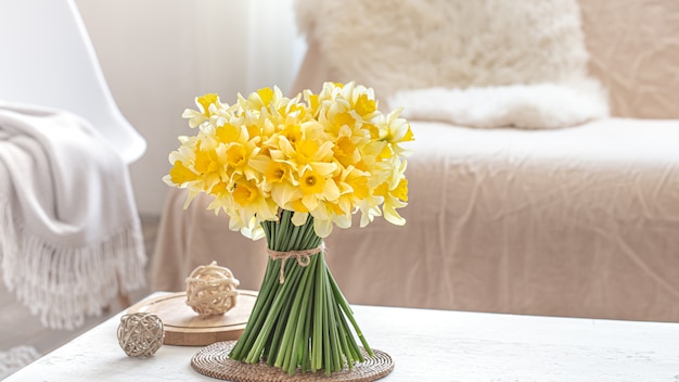 Flowers bouquet next to a sofa