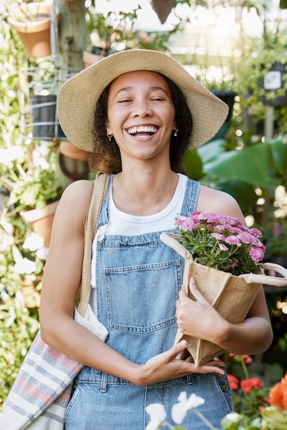 Flowers happy and woman at a plant nursery shopping for floral products for her garden in nature Happiness smile and young female florist from Mexico buying a flower bouquet at sustainable market