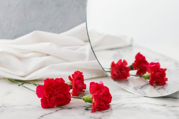 Flowers and mirror on table