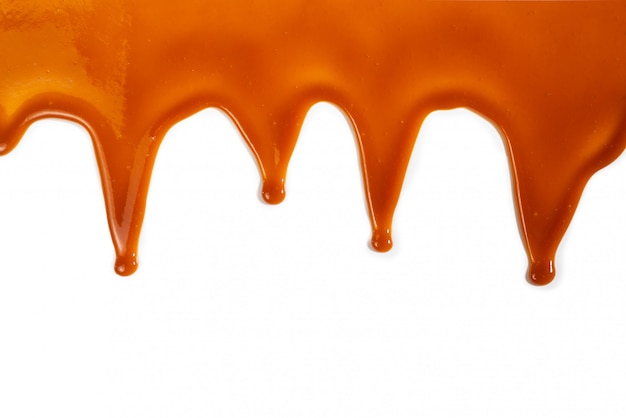 Flowing caramel sauce isolated 