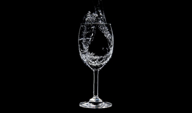 Flowing of water filling into Wine Glasses