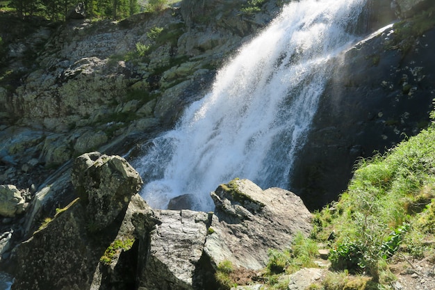 Flowing waterfall in sunny day