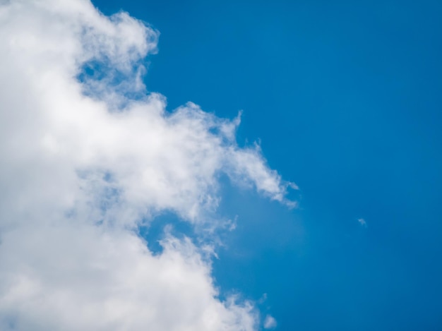 Fluffy big white clouds on the side and blue sky. Morning. Beauty nature environment background