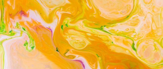 Fluid Art. Abstract blurred colorful background. Indian pattern vivid colors of yellow acid