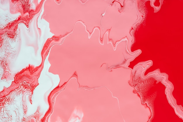 Fluid Art. Mixing red, white and pink acrylic paints. Abstract marble background or texture.