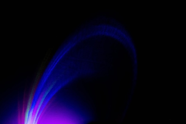 Fluorescent background UV radiance Defocused colorful blue purple magenta pink neon light glowing curve rays on dark black abstract futuristic wallpaper with empty space