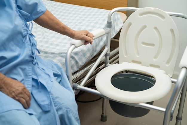 Flush toilet and shower chair in bathroom for old elder people