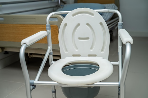 Flush toilet and shower chair in bathroom for old elder people