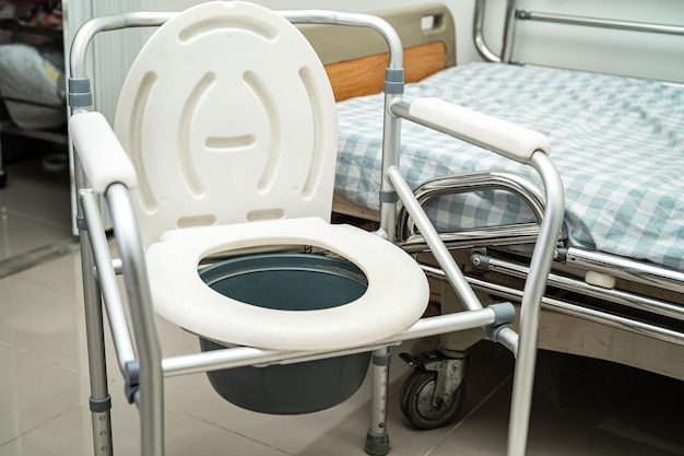 Flush toilet and shower chair in bathroom for old elder people