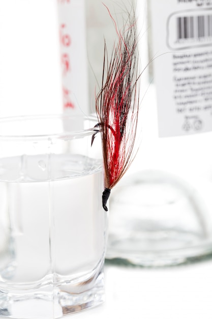 Fly fishing bait with glass and bottle alcohol