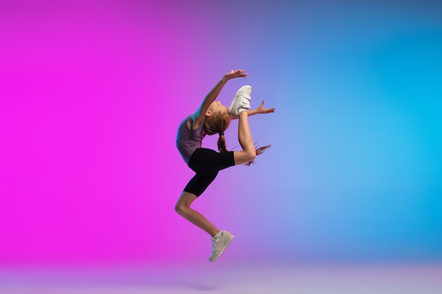 Flyer. Teenage girl, professional runner, jogger in action, motion isolated on gradient pink-blue