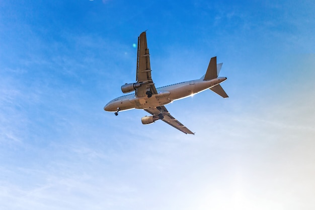 Flying aircraft with passengers over blue sky