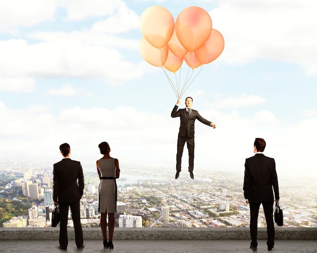 Flying balloons with Businessman