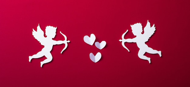 Flying cupid silhouette,  happy Valentine's Day banners, paper art style. Amour on red paper