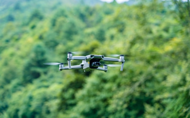 flying drone taking aerial view of greenery park.