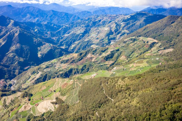 Flying drone towards beautiful amazing famous Mt. Hehuan in Taiwan over above the hilltop, aerial view shot.