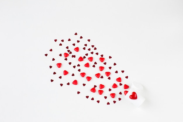 Flying red heart-shaped candies and confetti