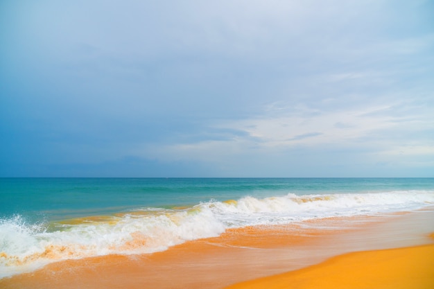 Foam wave, running on the sandy shore.