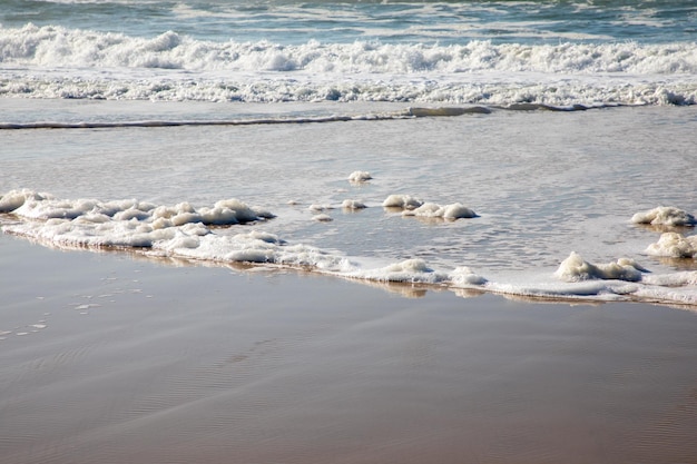 Foam wave water coming up sea beach sand coast