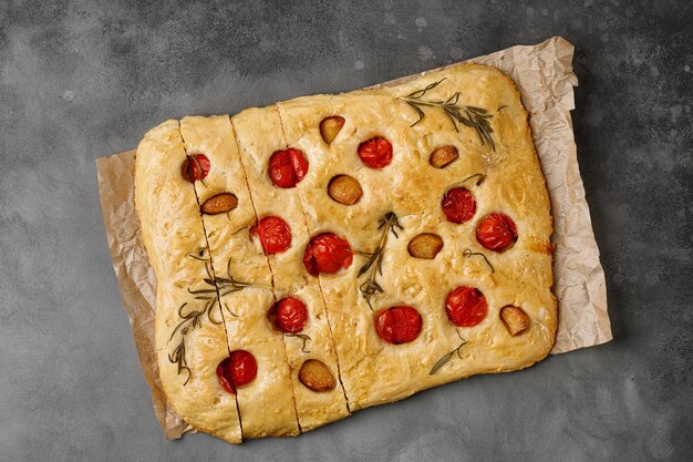 Focaccia bread with garlic cherry tomatoes rosemary Freshly homemade baked flat garlic bread