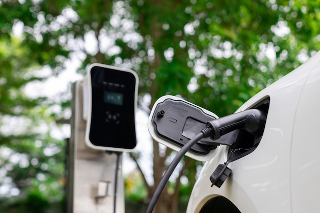 Focus closeup EV car and charger with blur background for progressive concept