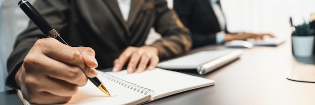 Focus closeup office worker's hand taking notes or writing Prodigy