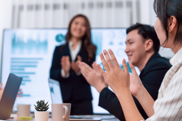 Focus hand applauding with blurred business people in harmony conference