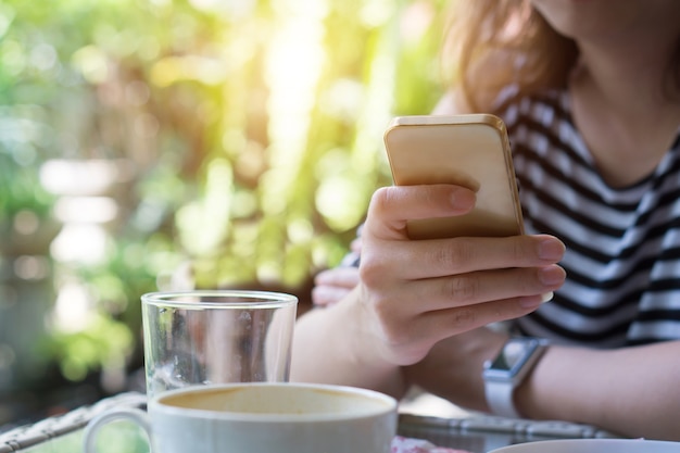 Focus hand of Young asian woman touching smartphone