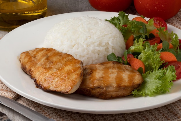 Focus on heathy food concept Grilled chicken rice and salad on plate