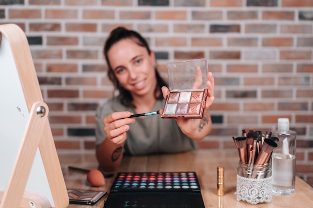 Photo focus of a makeup palette taught by a young streamer to her makeup channel