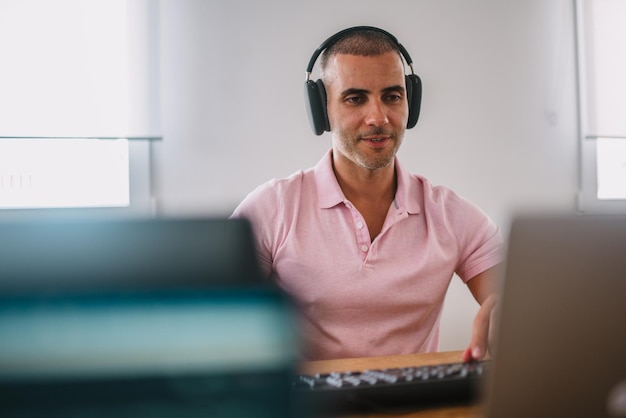 Focused business man entrepreneur with laptop and headphones Male professional using computer